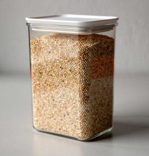 Een grote voorraadbus, gevuld met droge quinoa.