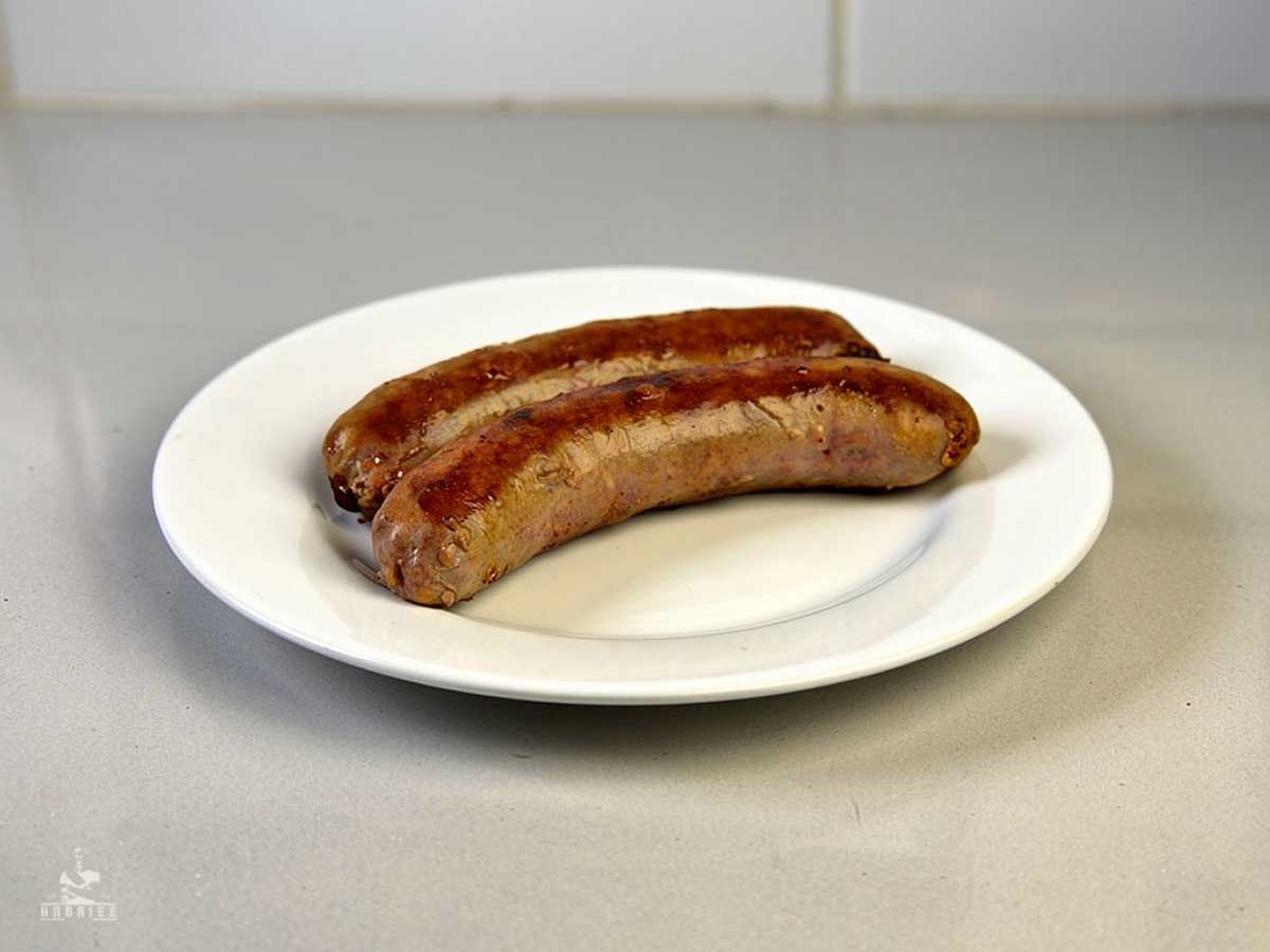 2 opgewarmde saucijsjes op een wt bord.