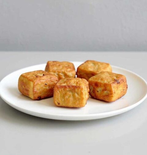 5 stukjes tahu goreng op een wit bordje.