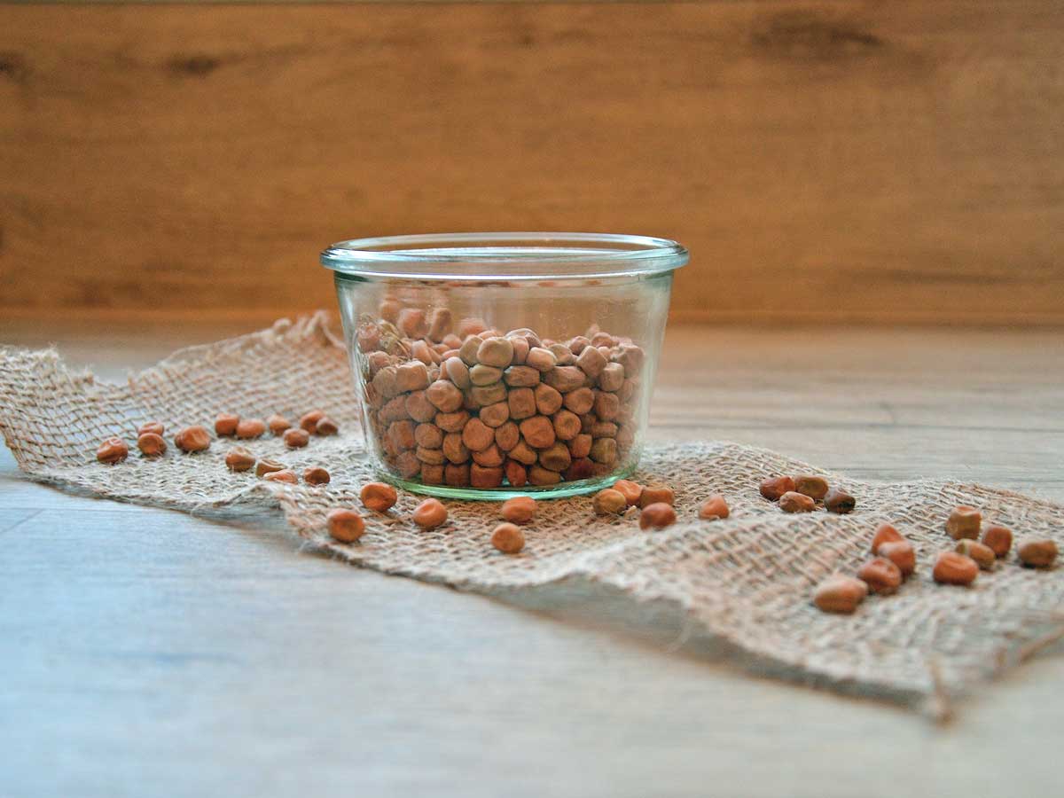 Gedroogde kapucijners in een glazen schaaltje op een soort loper.
